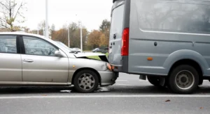 Smaller passenger vehicle colliding with a larger company vehicle or commercial vehicle due to tailgating or driving too closely.