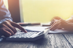 calculating car accident attorney fees at a desk