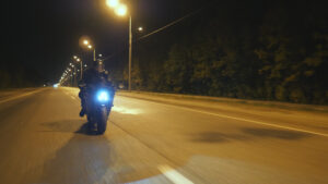 motorcyclist operating cautiously when riding at night to prevent a motorcycle accident