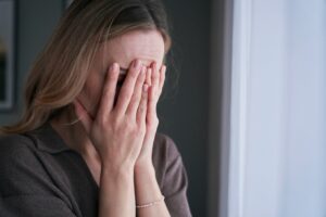 stressed female holding her face after a personal injury accident