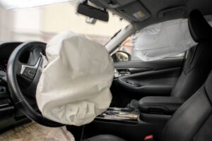 Car airbag deploying in a motor vehicle accident