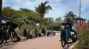 Electric bikes/bicycles, also referred to as e-bikes and electric scooters parked along a coastal street in California