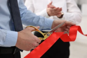 attorney conducting ribbon-cutting ceremony to represent new law office location opening in a new city