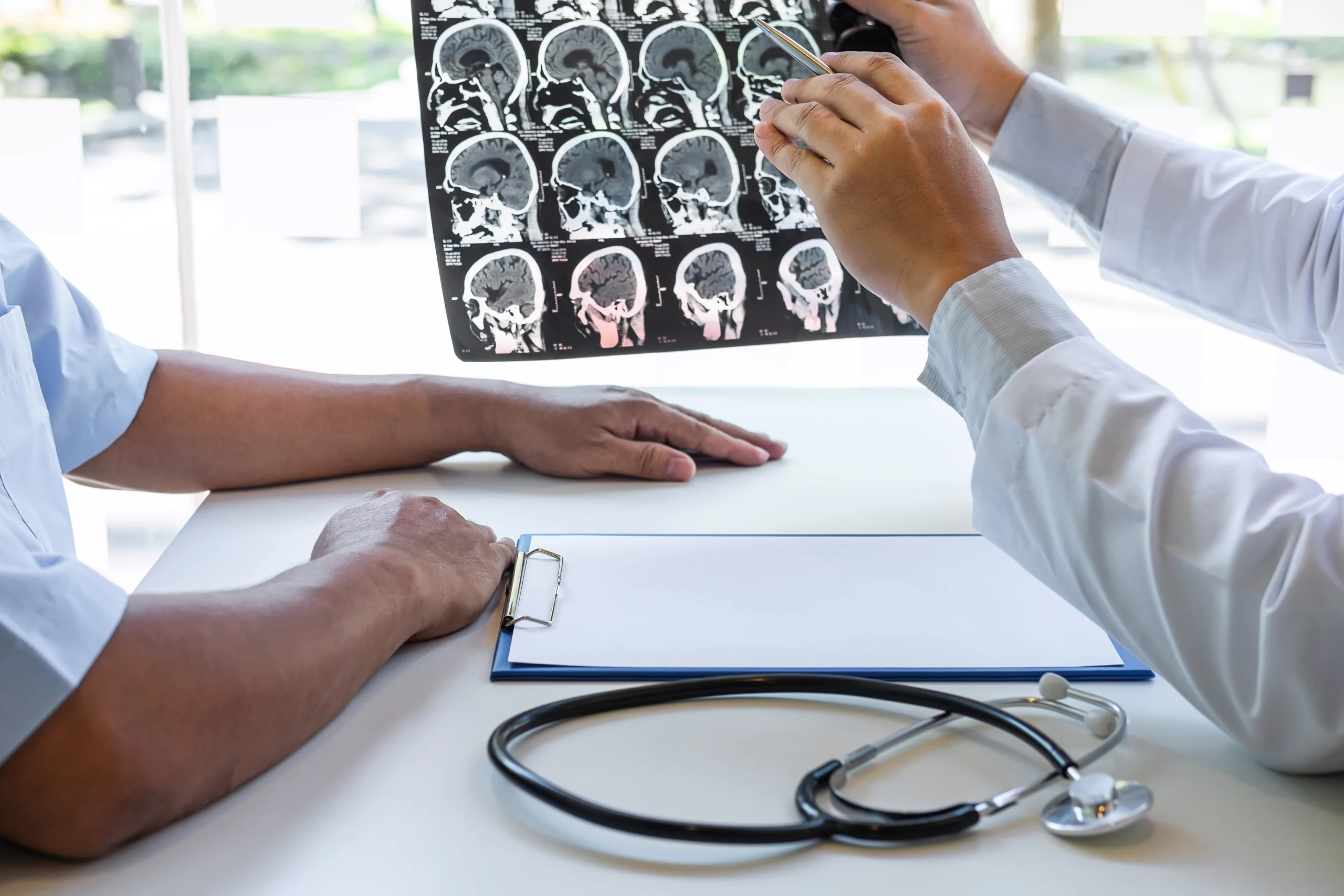 Doctor reviewing CT scans of a patient's skull following a personal injury accident where a traumatic brain injury (TBI) may have been sustained